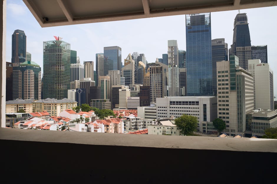 A stunning view of Singapore's skyscrapers captured from a window on a sunny day.